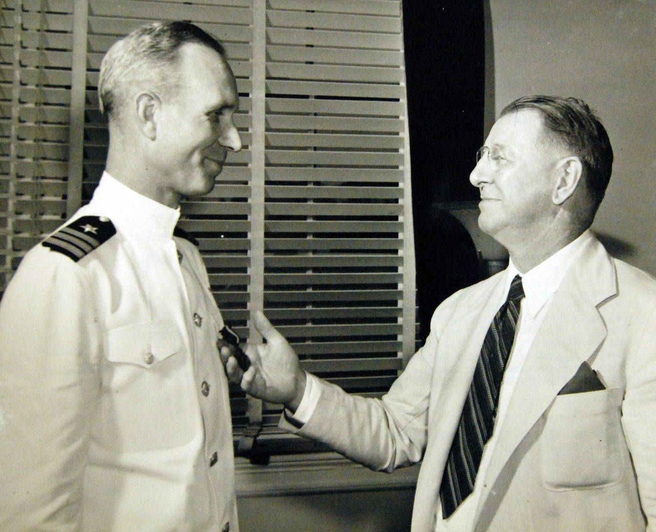 Lot-4263-32:  The Honorable Frank Knox, Secretary of the Navy, presents the Navy Cross to Commander Paul H. Talbot, USN, July 1l1, 1942.  Secretary of the Navy Frank Knox Collection.   Photographed through Mylar sleeve.  (2015/11/20).