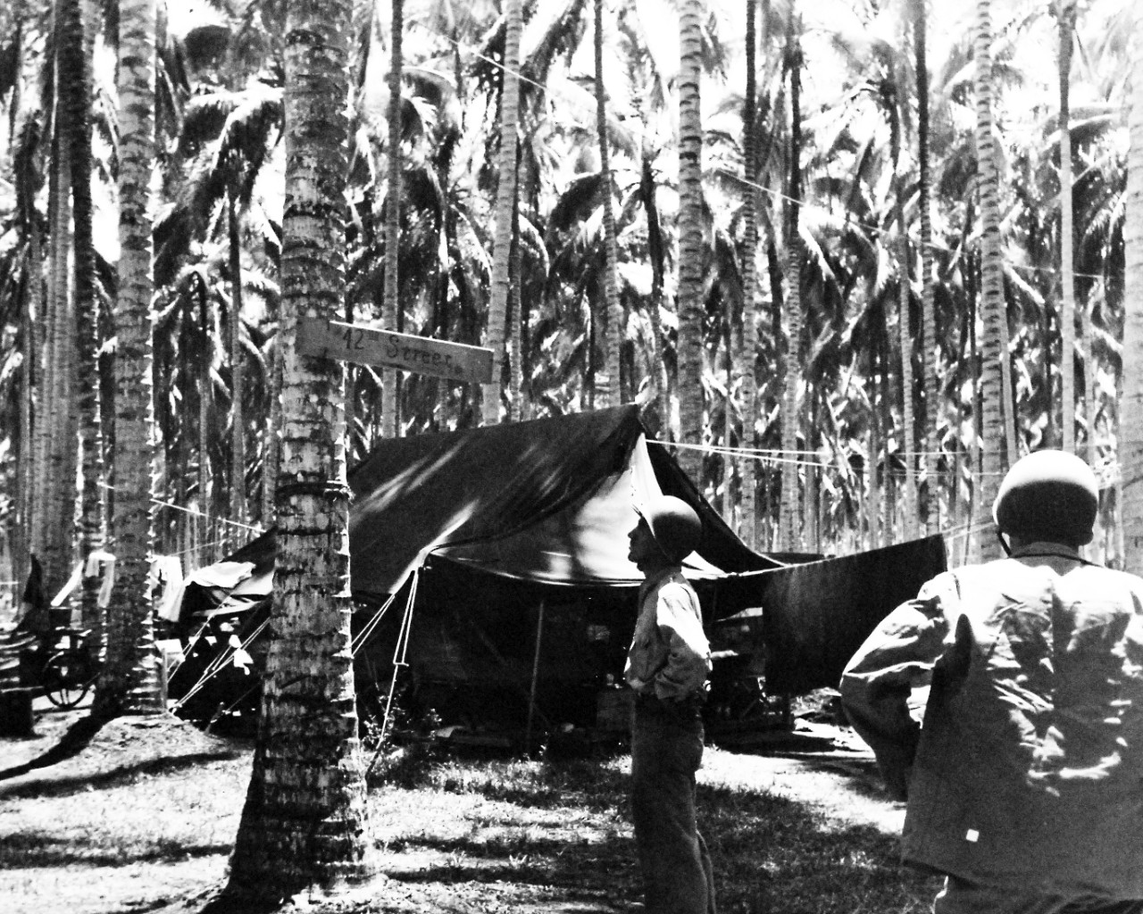 80-G-27200: Guadalcanal Campaign, August 1942 to February 1943.  A A Sign says “42nd Street”, but it is a long way from New York City’s Times Square.  The sign was posted at a U.S. Marine Camp on Guadalcanal, November 30, 1942.    Official U.S. Navy photograph, now in the collections of the National Archives.  (2016/12/06).