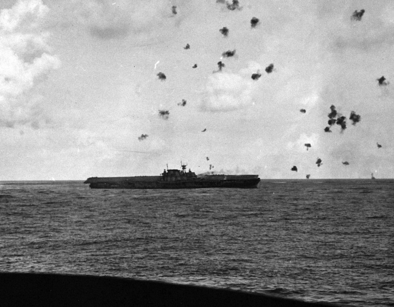 80-G-33898:  Battle of Santa Cruz Islands,  26 October 1942.   USS Hornet (CV 8) listing after the Japanese attack, she was abandoned at this point.   Photographed from USS Pensacola (CA 24).  U.S. Navy photograph, now in the collections of the National Archives.  (2015/11/17).