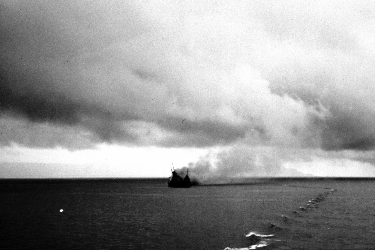 LC-Lot-801-16:  Battle of Savo Island, 9 August 1942.  HMAS Canberra, off Guadalcanal, smoking after badly damaged in combat with a force of Japanese cruisers.   She was later scuttled that day in “Iron Bottom Sound.”  Note, the destroyer next to her is probably USS Blue (DD 387). U.S. Navy Photograph. Photographed through Mylar sleeve. Courtesy of Library of Congress.  (2015/11/06).