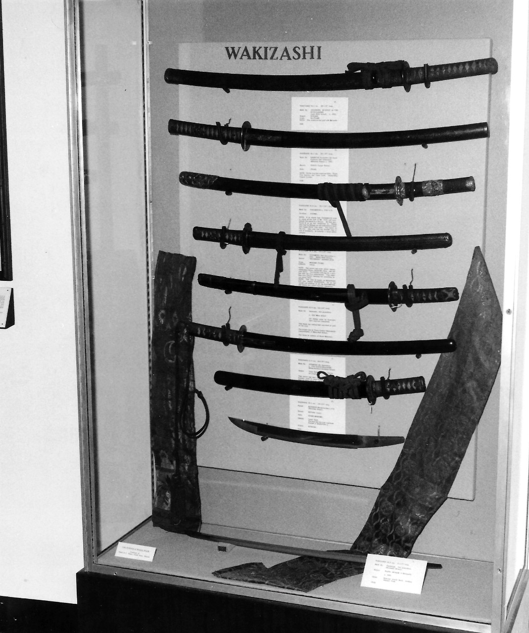 Samurai Swords Exhibit.   The Navy Memorial Museum (now National Museum of the Navy).  Shown:  Wakizashi exhibit case.   Exhibit was held from November 1977 to January 1978 and displayed thirty-seven swords from the collection of David E. J. Pepin.   National Museum of the U.S. Navy Photograph, NMUSN-Photo-13