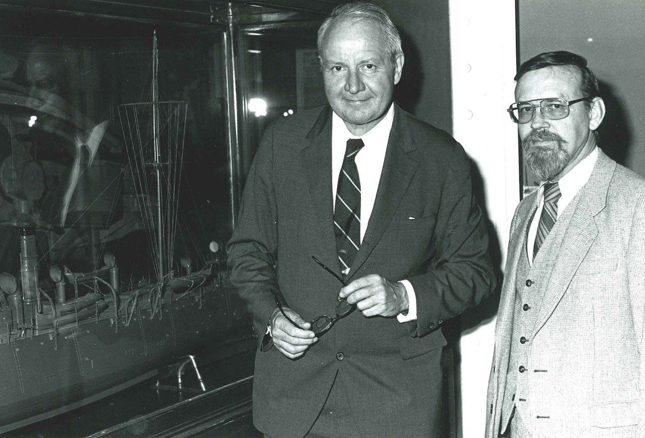 NMUSN-4402:   Mort Kunstler Art Exhibit,1982.   Former Secretary oi the Navy J. William Middendorf, along with an unidentified guest at the art exhibit opening.   National Museum of the U.S. Navy Photograph Collection.