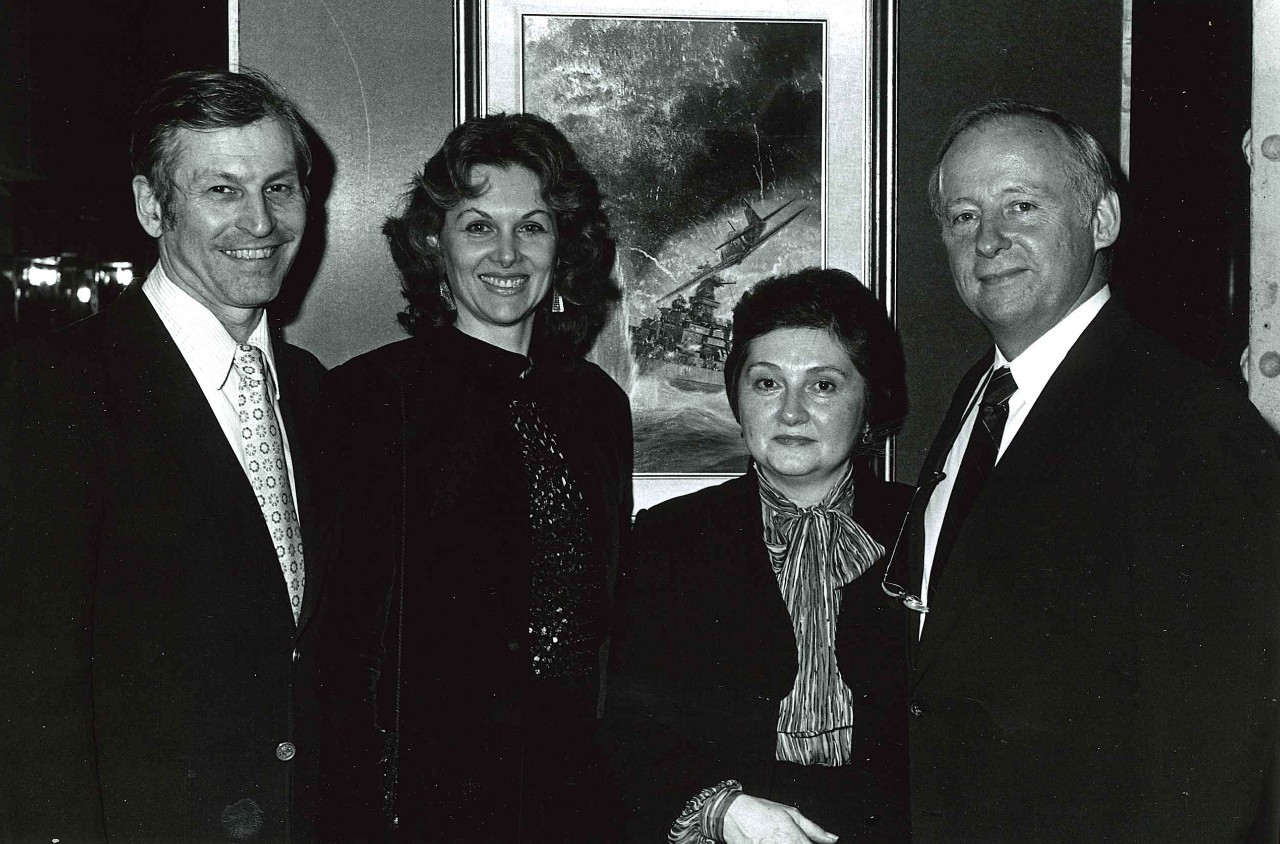 NMUSN-4405:   Mort Kunster  Art Exhibit, 1982.   Mort Kunstler, left, with two unidentified female guest, and Director of the Navy Memorial Museum, Commander Damon, to the right.    National Museum of the U.S. Navy Photograph Collection.  