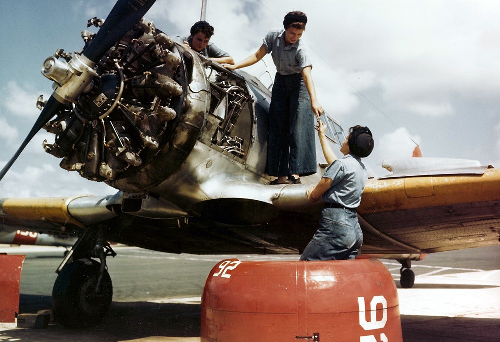 Naval Auxiliary Air Station, Whiting Field, Pensacola, Florida. WAVES aircraft mechanics working on a North American SNJ training plane, circa 1943-45. Note their dungaree uniforms. Official U.S. Navy Photograph, now in the National Archives, 80-...