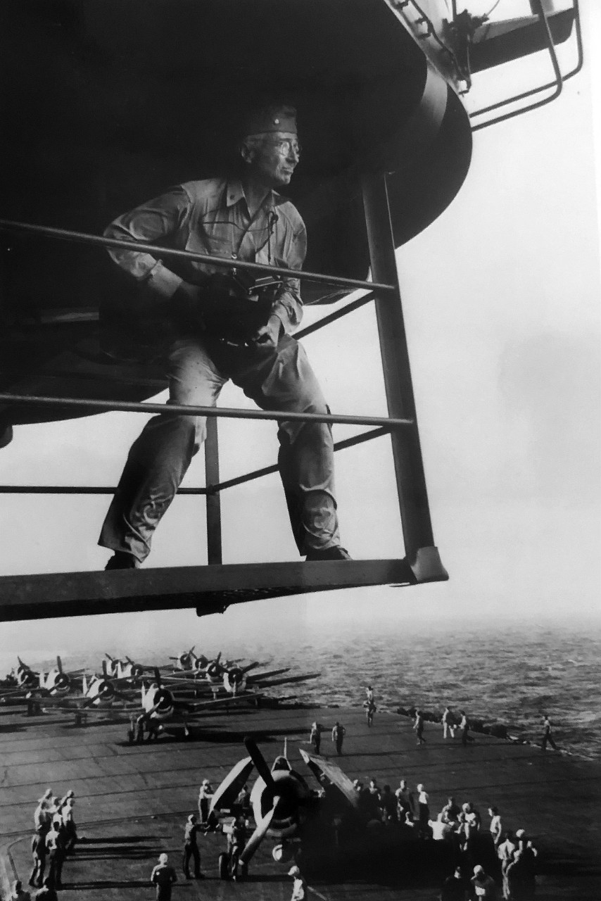 Commander Edward Steichen on USS Lexington (CV-16) with planes on deck below.   Composite photograph released on June 16, 1945.  Official U.S. Navy Photograph, now in the collections of the National Archives, 80-G-324556. 