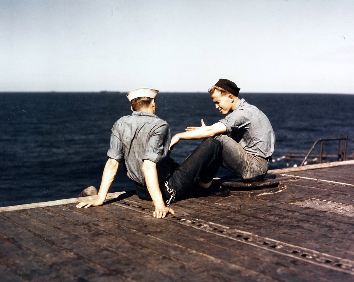 USS Lexington (CV-16), November-December 1943.   Two crewmen relax on the flight deck, during a lull in operations.  Man at right is sitting on an arresting cable.   Photographed by Edward Steichen.  Official U.S. Navy Photograph, now in the collections of the National Archives, 80-G-K-15558. 