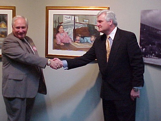 NMUSN-5176: Visions of Infamy Exhibit, December 2001. Artist Tom Freeman shakes the hand of Mr. Bryant Costellow, a subject of one of his paintings at the Navy Museum (now National Museum of the U.S. Navy), Washington Navy Yard, Washington, D.C. ...