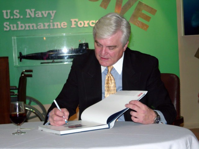 NMUSN-5180: Visions of Infamy Exhibit, December 2001. Artist Tom Freeman signs a copy of his book Pearl Harbor Recalled: New Images of the Day of Infamy in-front of the Dive! Dive! Dive! submarine exhibit at the Navy Museum (now National Museum o...