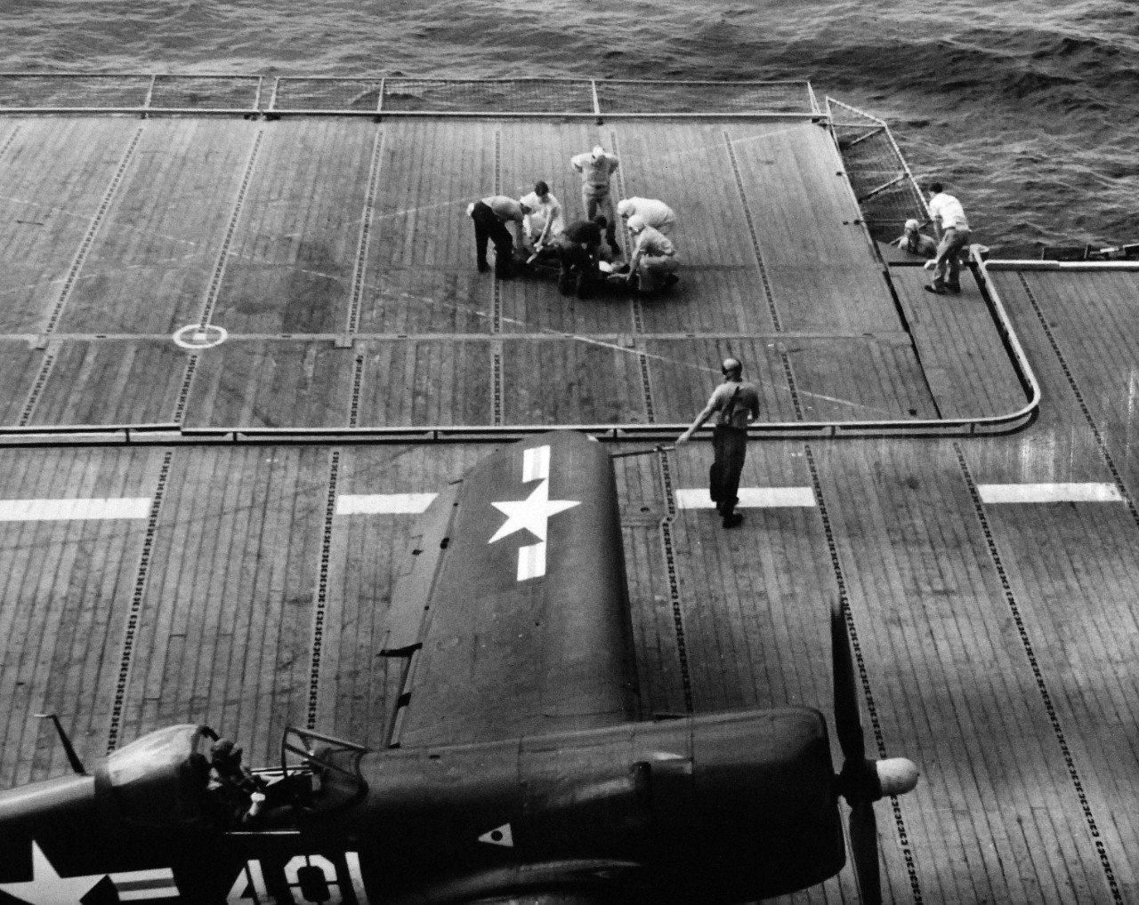 USN 710026:  Ill-fated take off of F4U from USS Boxer (CV-21) operating with Task Force 77, off Inchon, Korea, September 16, 1950.  Pilot was Ensign James Brogan, USN.   Rescued pilot suffering from shock and superficial burns is transferred to sick bay.  This image is provided to show the courage it took to fly during these initial missions.      Official U.S. Navy Photograph, now in the collections of the National Archives.  