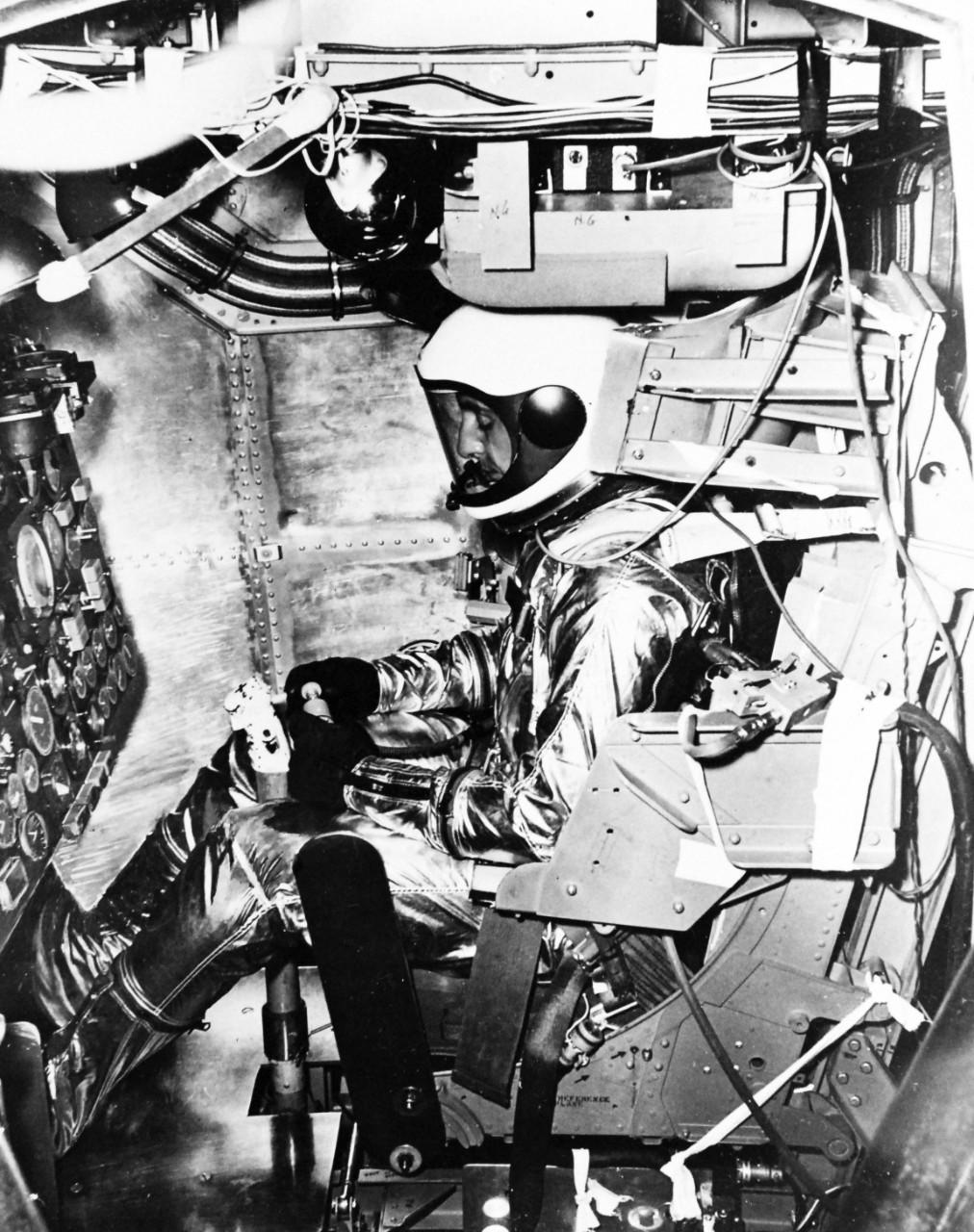 USN 1036462:  Aviation Medical Accelerator Laboratory (AMAL), late 1950s.   Space Suit.  All set for a “Flight Unto Space” test pilot Scott Crossfield, of North American Aviation readies himself at the controls of the X-15 before beginning a test run.  The flight will chart the effects of combined accelerations on pilots during high speeds, late 1950s. AMAL is noted for being used for flight simulation training for the Project Mercury astronauts.    Official U.S. Navy Photograph, now in the collections of the National Archives.  