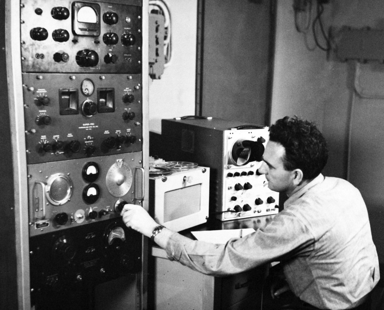 330-PS-8850-4:  U.S. Navy Conducts Physical Studies By Telephone.  Typical shipboard unit for receiving physiological information as transmitted by radio manned by Radioman Second Class Leonard Williams, USN, March 21, 1958.  Official Department of Defense photograph, now in the collection of the National Archives.   