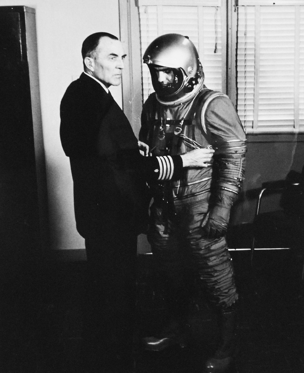 330-PS-8850-6:  U.S. Navy Conducts Physical Studies By Telephone.  Captain Norman Lee Barr, MC, USN, connects electrode lands from subject dressed for high-altitude flight, March 21, 1958.  Official Department of Defense photograph, now in the collection of the National Archives.   