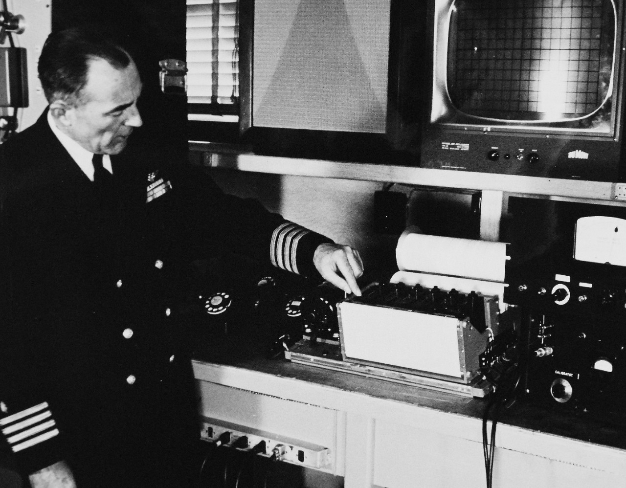 330-PS-8850-7:  U.S. Navy Conducts Physical Studies By Telephone.  Captain Norman Lee Barr, MC, USN, examines an ink-writer that is used to record the physiological information transmitted over telephone lines, March 21, 1958.  Official Department of Defense photograph, now in the collection of the National Archives.   