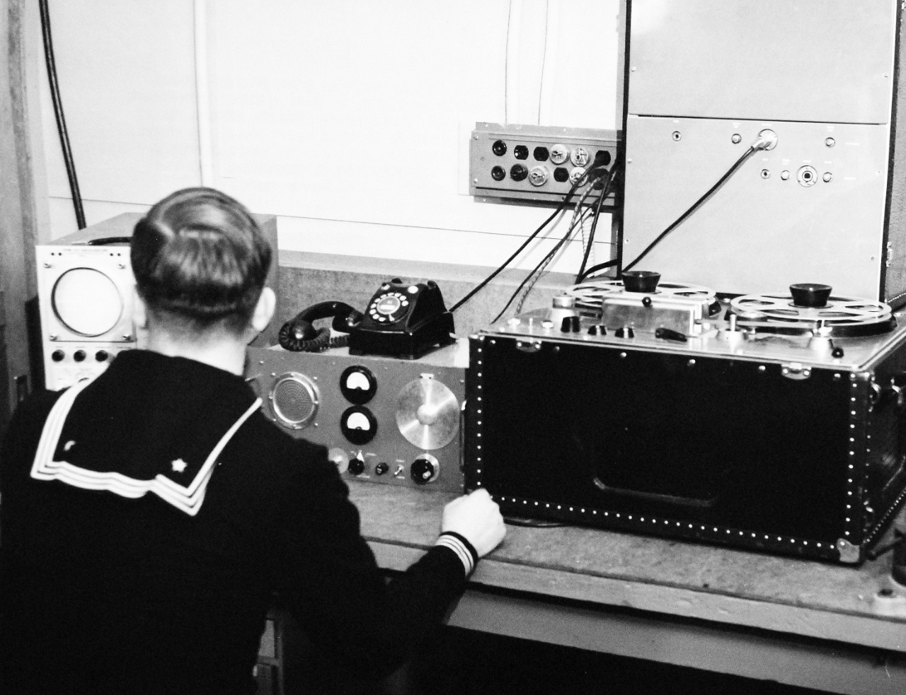 330-PS-8850-8:  U.S. Navy Conducts Physical Studies By Telephone.  Electronics Technician John J. Rhinehart, USN, manning a typical shore-based receiving unit for the transmission of physiological information by radio or telephone, March 21, 1958.  Official Department of Defense photograph, now in the collection of the National Archives.   