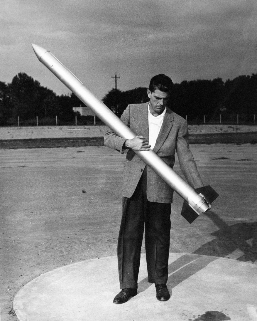 330-PS-9191 (USN 7109279)   Mr. Nelson Sublett holds the U.S. Navy’s Argas rocket, a 72-pound, six food single stage rocket.   Mr. Sublett words for the Office of Naval Research, 15 October 1958.   Official U.S. Navy photograph, now in the collections of the National Archives.     