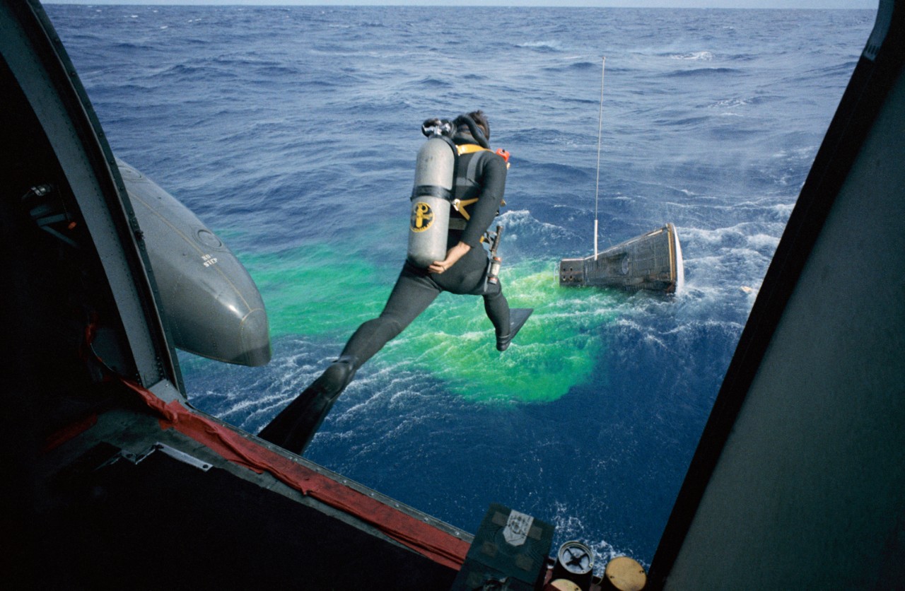 1966 - Splashdown USA A frogman of the U.S. Navy’s Underwater Demolition Team (UDT) leaps in full gear into the Atlantic to retrieve the Astronauts James Lovell and Buzz Aldrin of Gemini XII. UDT members (forerunners of the Navy’s SEAL teams) trained for months with practice space capsules to ensure the safe retrieval of both the Astronauts and the capsule. The Navy’s return address for capsule recovery operations was officially known as “Splashdown USA.” (Photo courtesy of NASA)