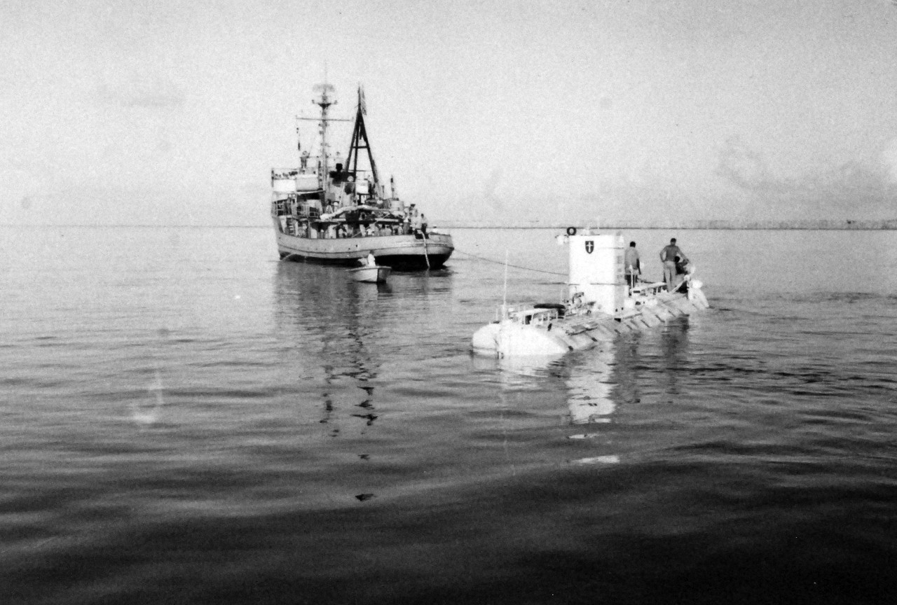 428-GX-KN 691:  U.S. Navy Bathyscaph Trieste, 1959.   Trieste being towed to sea by USS Wandank (ATA 204) for an ocean dive off the coast of Guam, November 10, 1959.  U.S. Navy Photograph now in the collections of the National Archives.  Note, photographed from reference card only and black and white only.  (2016/02/17).   