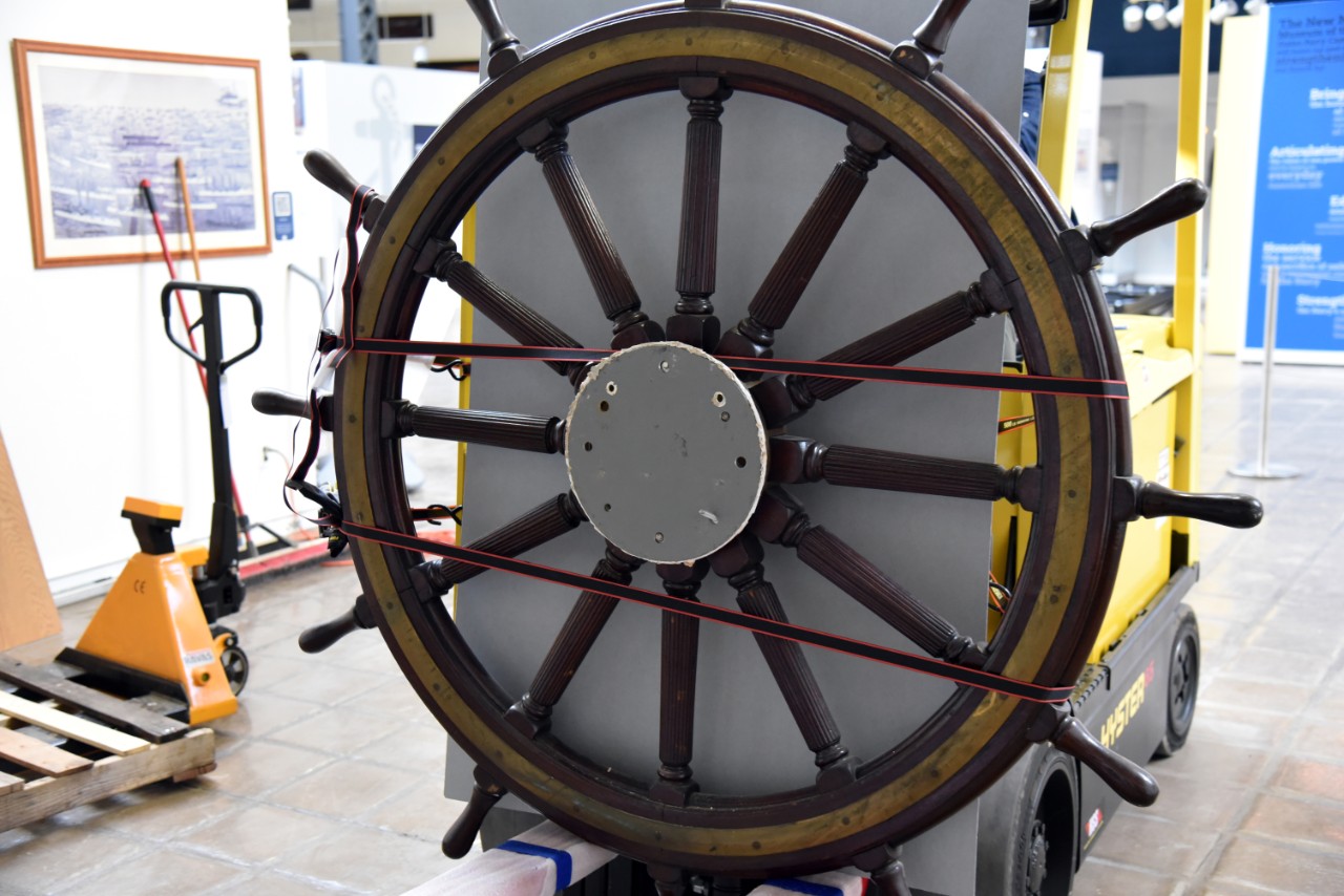 NMUSN-5139: Protected cruiser Albany’s Helm Wheel, December 2022. Wheel has been taken off display from the Spanish-American War exhibit area and is being transported by forklift. Official U.S. National Museum of the U.S. Navy Photograph. Digital...