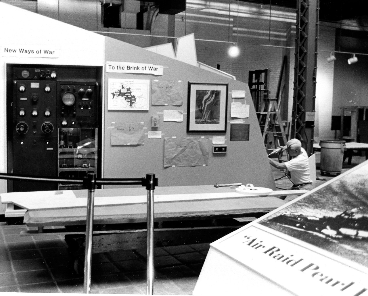 NMUSN-161:  In Harm’s Way:  Atlantic, late 1980s.   National Museum of the U.S. Navy, Bldg. 76.  Exhibit Specialist Mr. Kim builds “To the Brink of War” part of the exhibit.    Note the XAF radar to the far left under the banner of “New Ways of War”.    National Museum of the U.S. Navy Photograph Collection.  