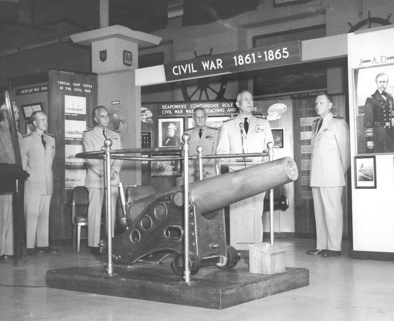 NMUSN-28:    Presentation of 20-Pounder Dahlgren Gun, Navy Memorial Museum, July 1968.    Admiral Willard J. Smith, Commandant, U.S. Coast Guard presents the gun in a formal ceremony.   Others in attendance.   Shown, left to right:   Rear Admiral Ernest M. Eller (blocked by exhibit case); Rear Admiral R.W. Goehring; Admiral Willard J. Smith, Commandant U.S. Coast Guard; Rear Admiral Elliott Loughlin; Admiral Thomas H. Moorer, Chief of Naval Operations (speaking); and Captain Roy C. Smith, Director, Navy Memorial Museum.    This artifact is now on display by the frigate, USS Constitution, Fighting Top Area.    National Museum of the U.S. Navy Photograph Collection.   