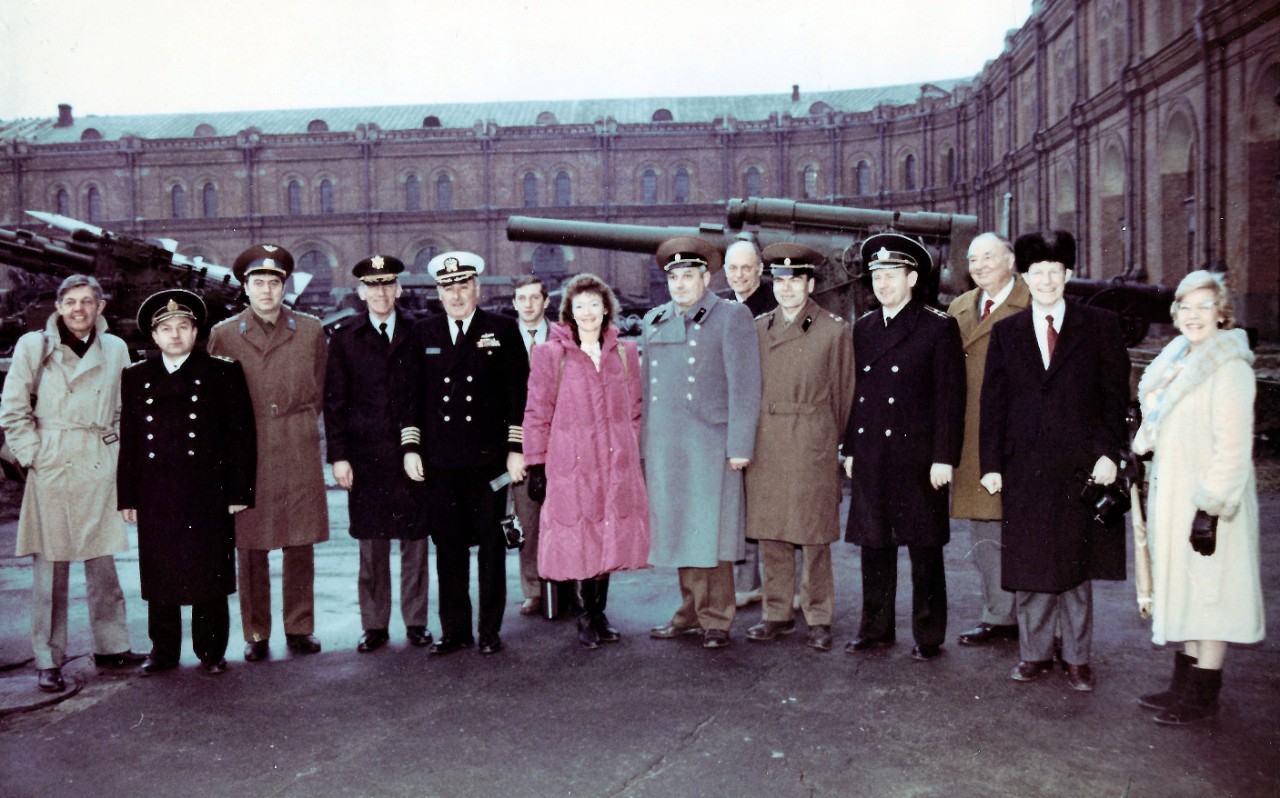 NMUSN-129:   Museum of Artillery, Engineers, and Signal Corps, February-March 1989.   The Navy Museum’s Director, Oscar P. Fitzgerald, Ph.D. is the second from right.    The Deputy Director of the Navy Museum, Ms. Claudia Pennington is in the center with pink coat.   Naval Aviation Museum Director, Robert L. Rasmussen is on the far left.   This photograph was taken following the Soviet Military Museum contingent which visited the United States in December 1988.   The Chairman of the U.S. Joint Chiefs of Staff and his Soviet counterpart, Marshal of the USSR, Sergei F. Akrohomeyev, approved an exchange of military museum directors in 1987.  This exchange promoted better understanding between the two countries.    National Museum of the U.S. Navy Photograph Collection.  