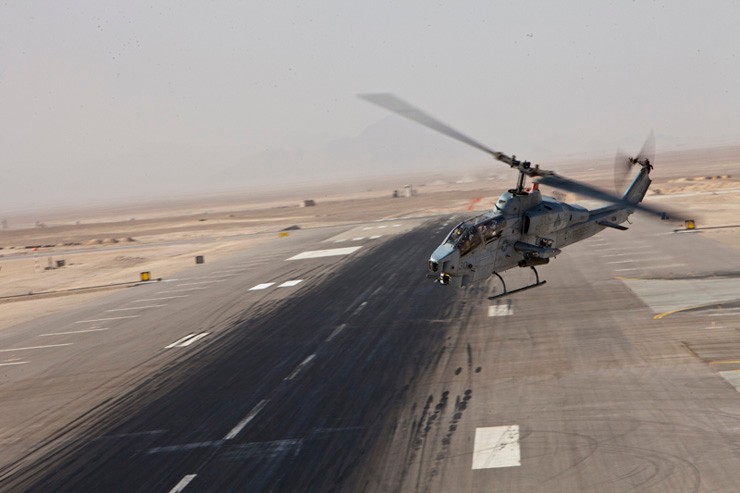 Photo of an AH-1W SuperCobra launching on a mission during operations in Afghanistan