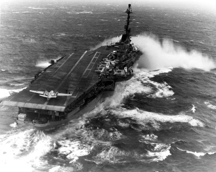 Photo of a TF-1 Trader positioned for a deck launch from an aircraft carrier in heavy seas.