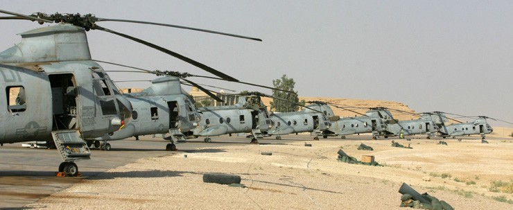 Photo of Marine Corps CH-46E Sea Knight helicopters lined up at Al Asad Air Base in Iraq.