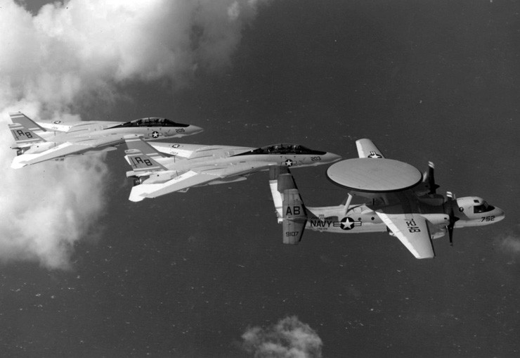 Photo of an E-2 Hawkeye flying in formation with F-14 Tomcats.