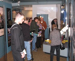 people walking through the USS Stennis exhibit