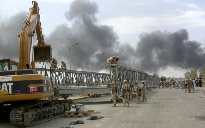 Seabees of Naval Mobile Construction Battalion 74 pre-position Steel Medium Girder Bridging for future river-crossing operations, pictured here February 10, 2003. 