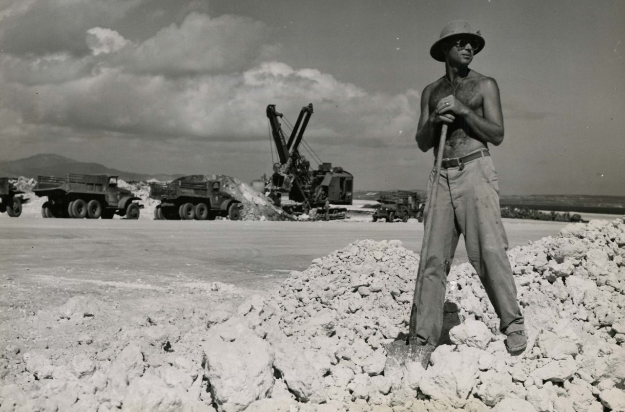 Seabees lay down coral for runway on Tinian.
