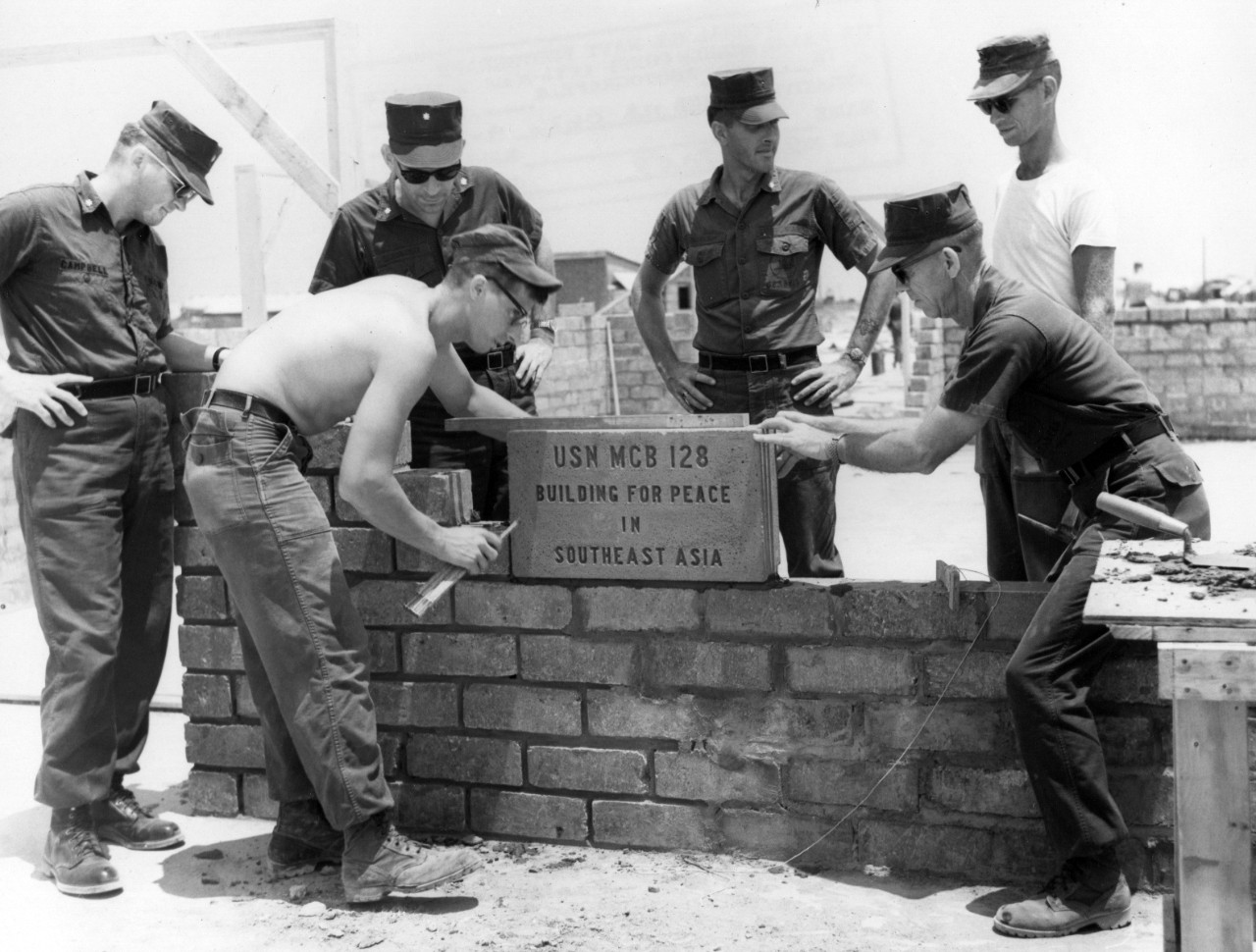 <p>Seabees assigned to Naval Mobile Construction Battalion 128 lay the cornerstone at a children’s hospital as part of a civic action project during their 1969 deployment to Vietnam.&nbsp;</p>
