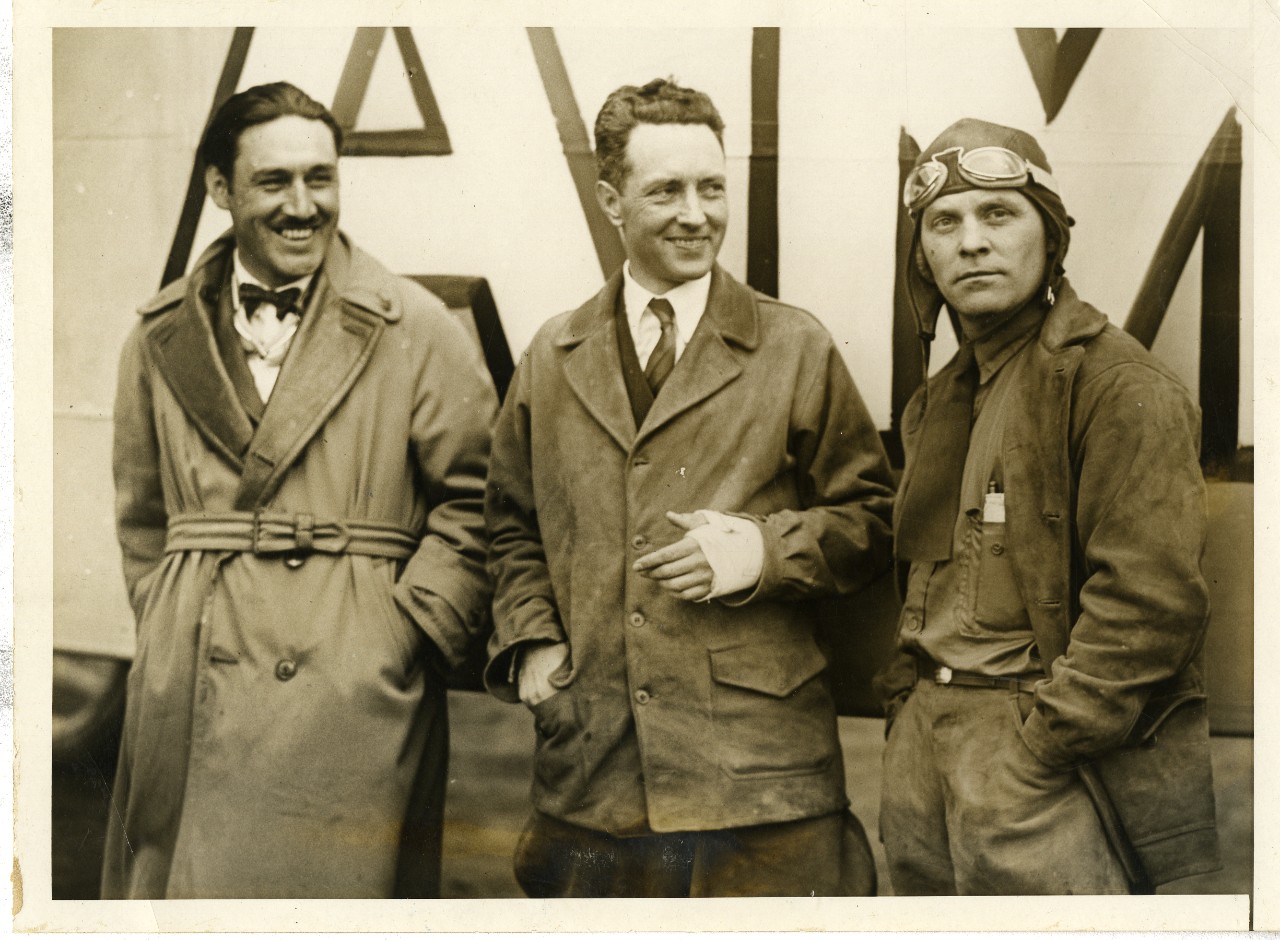 <p>Black and white photograph of&nbsp;Rear Admiral Richard E. Byrd (middle), alongside Leuitenant George Noville (right), and Bert Acosta (left) prior to their flight to Paris in aircraft &quot;America&quot;, circa 1927</p>