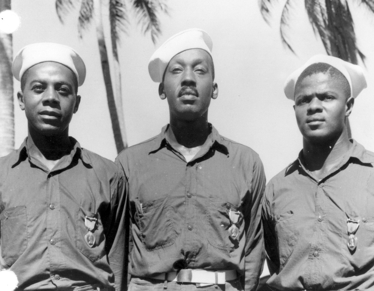 3 Men posing for a picture from the 34th Naval Construction Battalion. Photo is from the shoulders up.