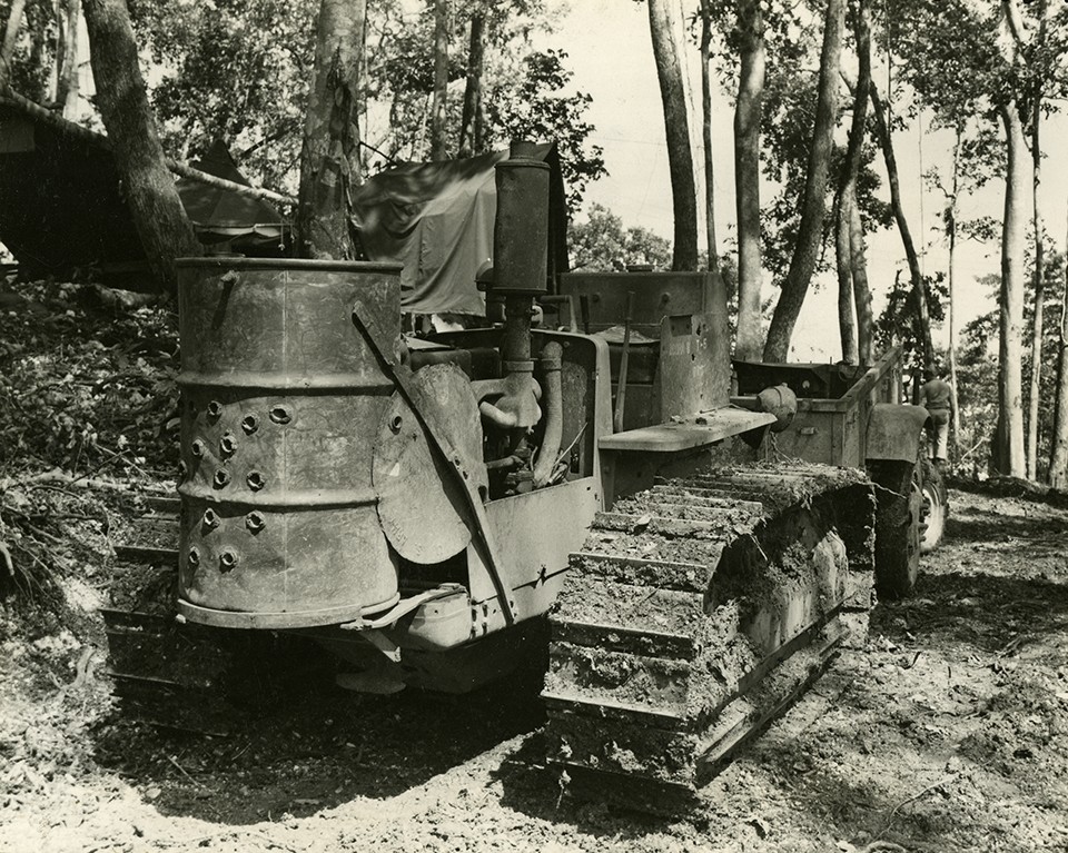 <p>Photograph of bulldozer with improvised 55-gallon drum, Walsworth photo, WWII</p>
