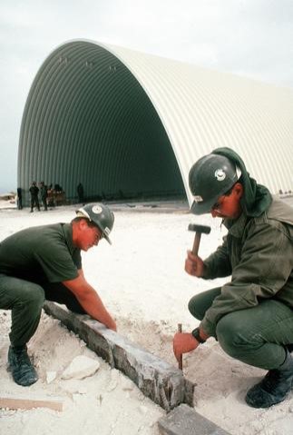 <p>K-Span buildings are pre-engineered structures used predominantly for open storage. The Seabees first used this type of construction during Operation Desert Shield/ Operation Desert Storm. Exact location unknown, 1990.</p>

