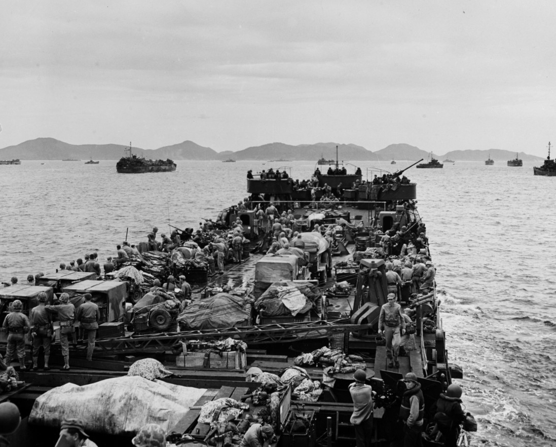 Ryukyus Campaign: An LST, loaded to the gunwales, approaches the beach on Iheya Jima, a strategic island about 15 miles northwest of Okinawa, on D-day, 3 June 1945. Equipment and American troops fill the small ship as it nears its objective.