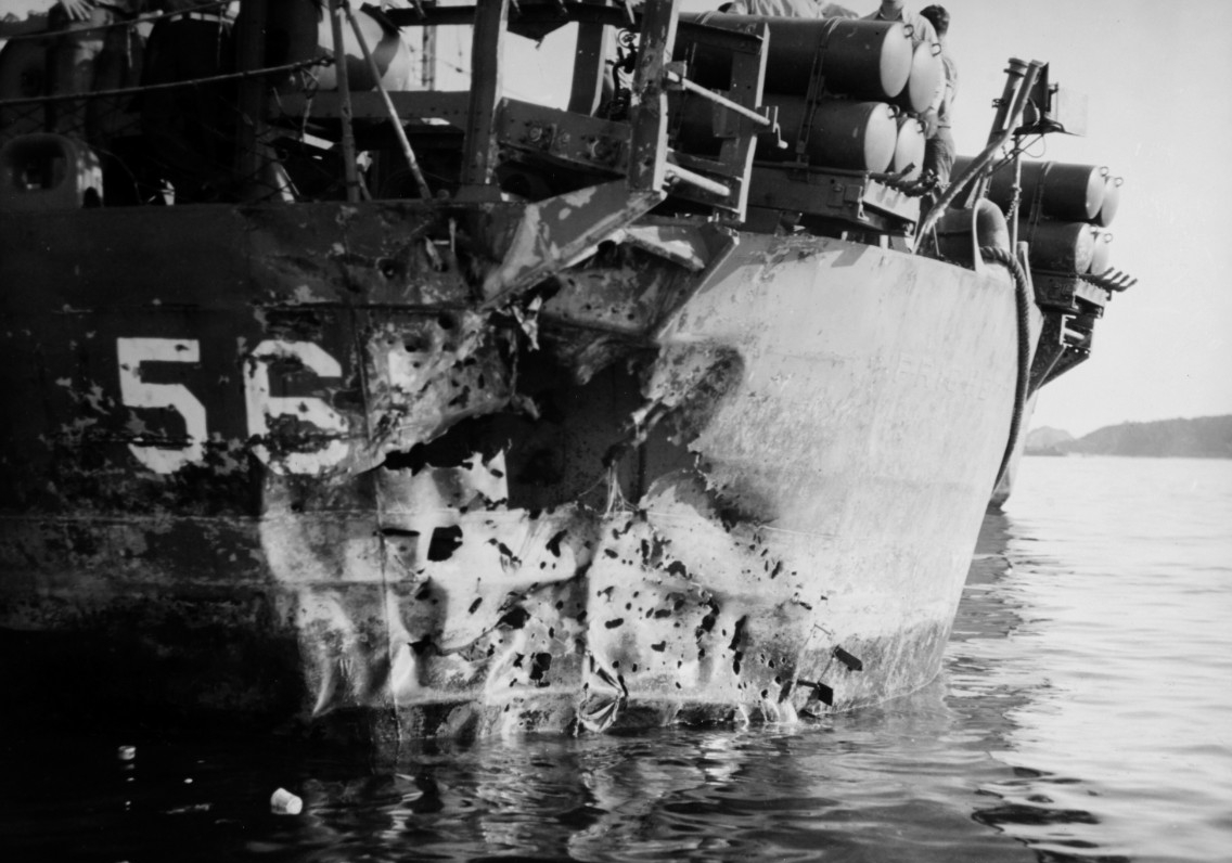 The stern of a ship, Pritchett, seen with blast holes and twisted metal above