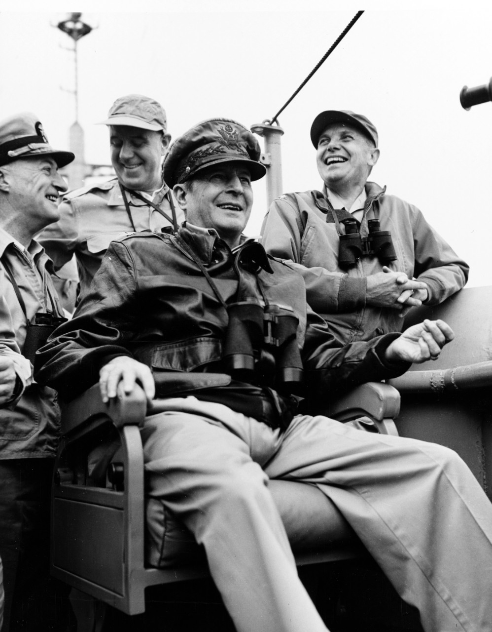 General of the Army Douglas MacArthur (seated, center), Commander-in-Chief, Far East Command, on board USS Mount McKinley (AGC-7) during the Inchon landings, 15 September 1950.