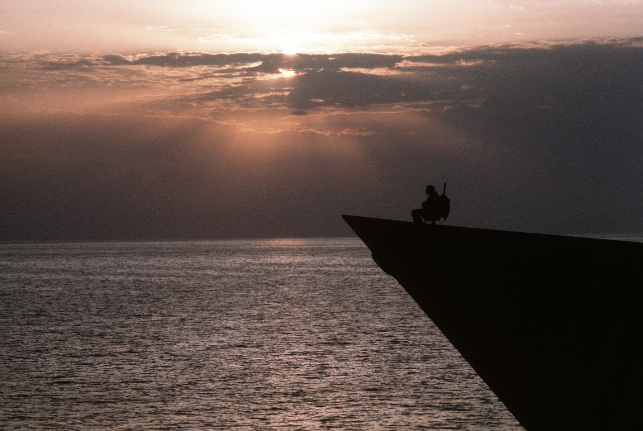 A Sailor stands watch at the bow of a ship on patrol in the Gulf during Operation Desert Shield/Operation Desert Storm, 1/1/1990. 