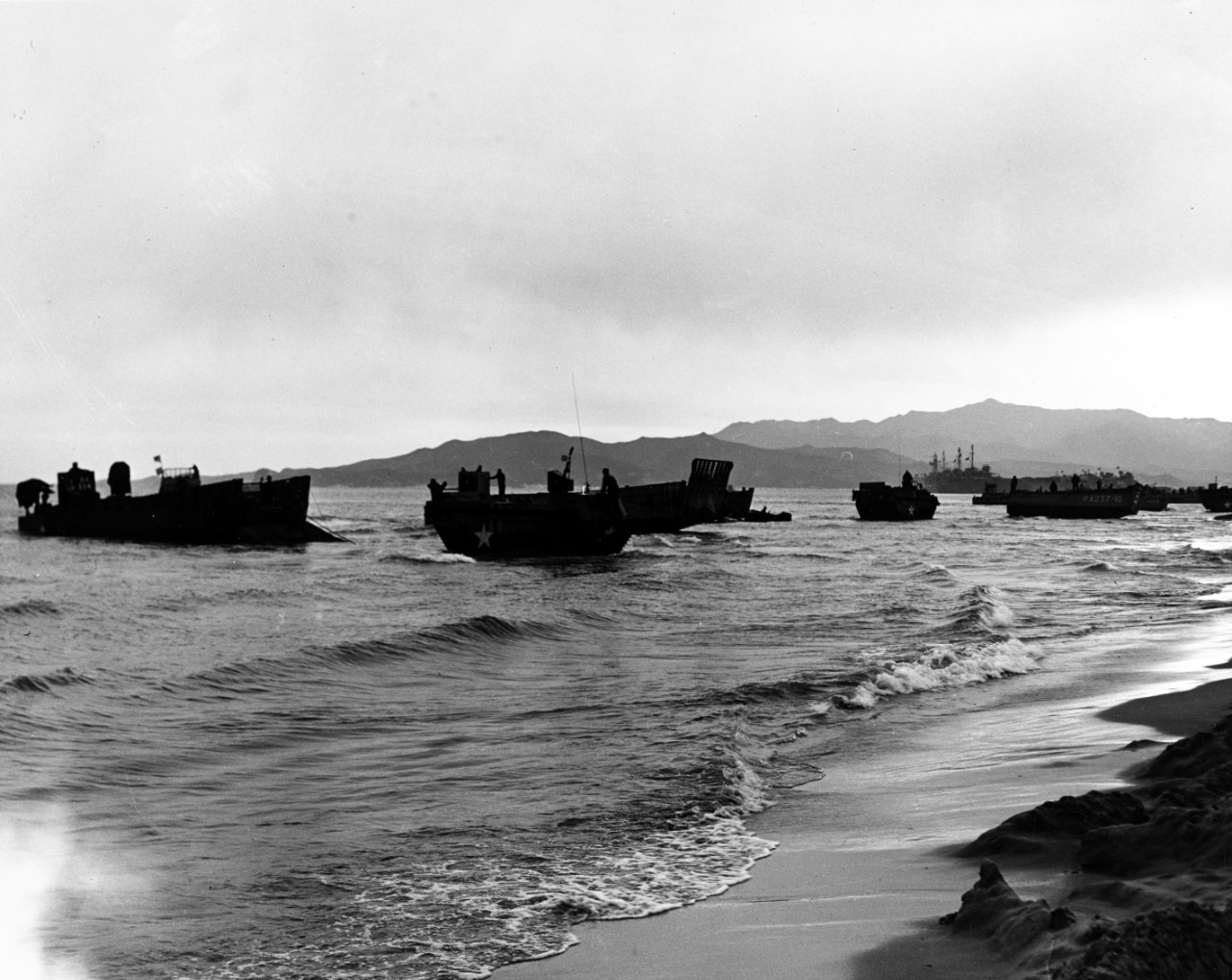LCMs unloading on the Kalmo Pando beaches, at Wonsan, North Korea, with LVTs standing by to assist, 26 October 1950.