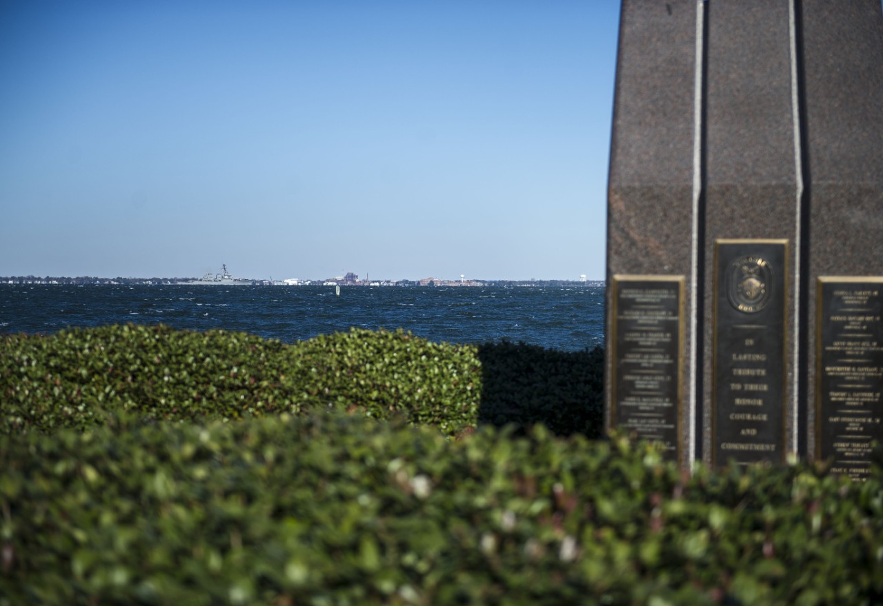 NORFOLK (Dec. 15, 2016) USS Cole (DDG 67), a guided-missile destroyer, passes the USS Cole Memorial as the destroyer departed Naval Station Norfolk for a scheduled deployment to the 5th and 6th fleet areas of responsibility. (U.S. Navy photo by Petty Officer 2nd Class Justin Wolpert/Released)