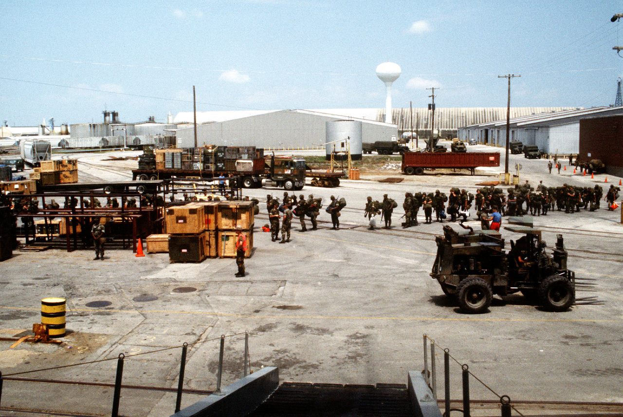 Marines lining up at a pier.