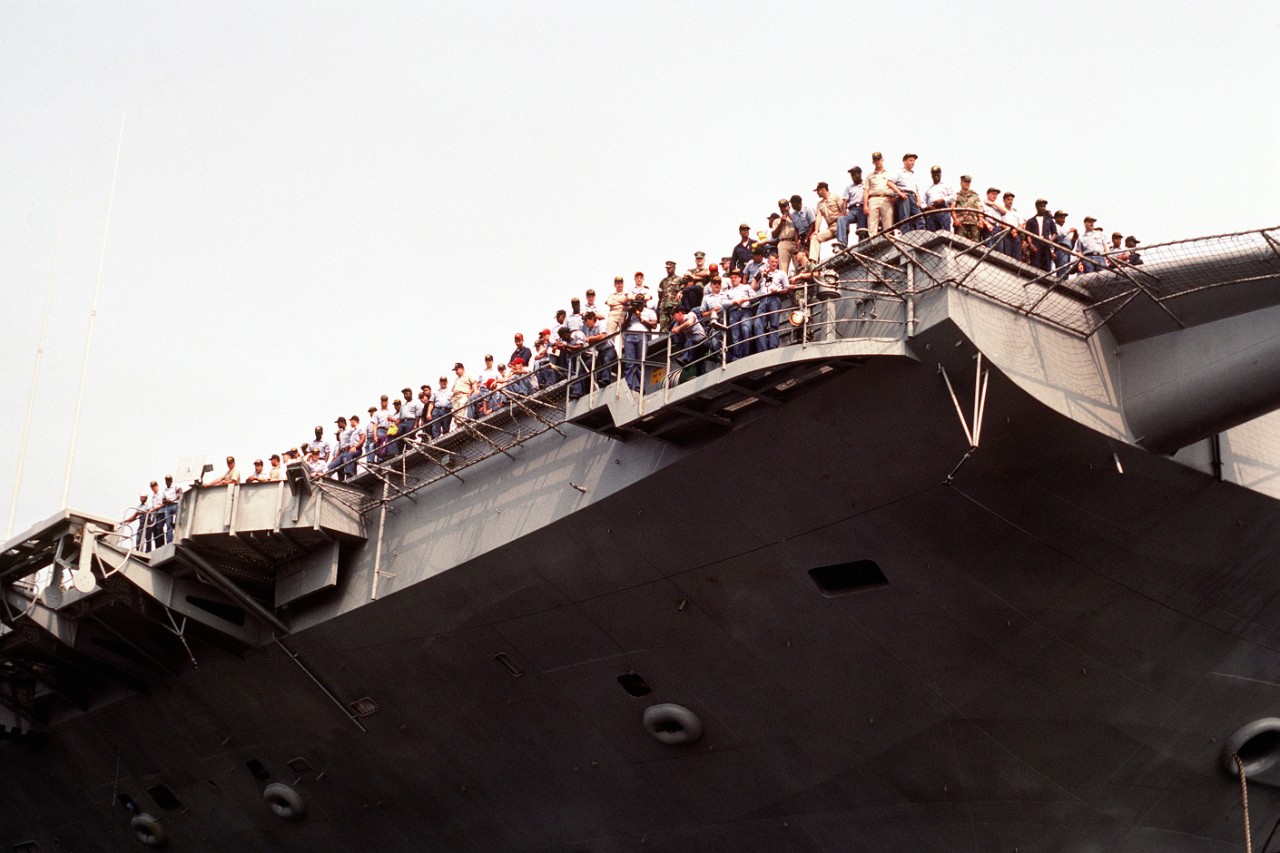 Sailors gather at the bow of the aircraft carrier USS John F. Kennedy (CV-67)