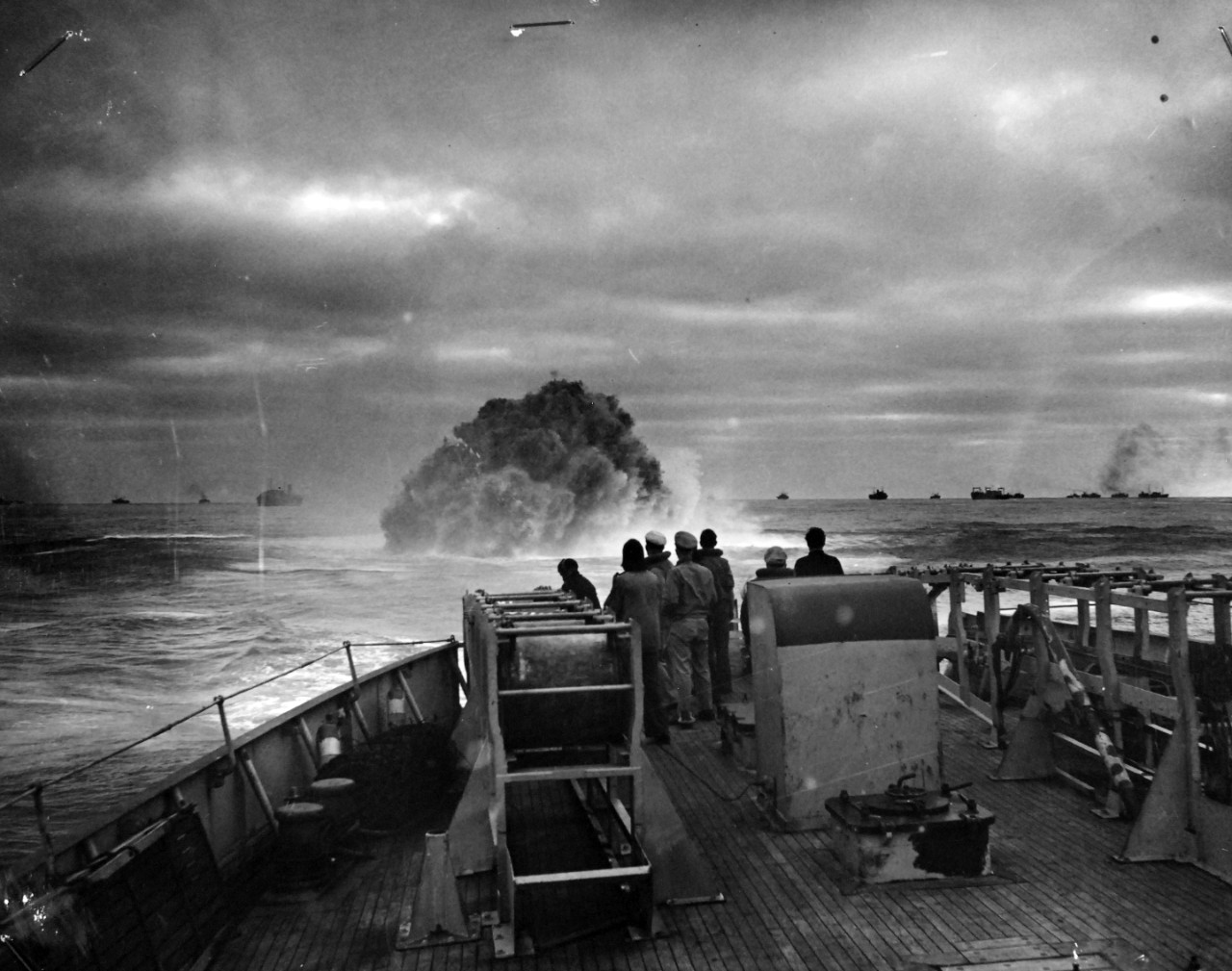 26-G-1517:  Sinking of German submarine U-175, April  1943.   The submarine was sunk off south-west of Ireland by USCGC Spencer (WPG-36) on April 17, 1943.  Official Caption: "COAST GUARD CUTTER SINKS SUB: Coast Guardsmen on the deck of the U.S. Coast Guard Cutter USCGC SPENCER (WPG-36) watch the explosion of a depth charge which blasted a Nazi U-Boat's hope of breaking into the center of a large convoy.  The depth charge tossed from the 327-foot cutter blew the submarine to the surface, where it was engaged by Coast Guardsmen.  Ships of the convoy may be seen in the background."  Date: 17 April 1943.  Official U.S. Coast Guard Photograph, now in the collections of the National Archives.  (2017/09/05).