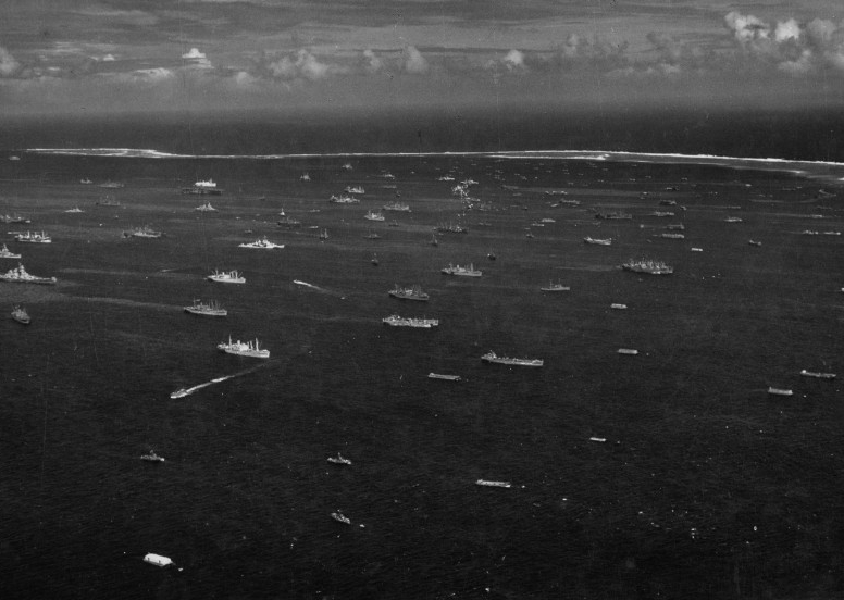 Aerial black-and-white photograph of a harbor full of ships. 