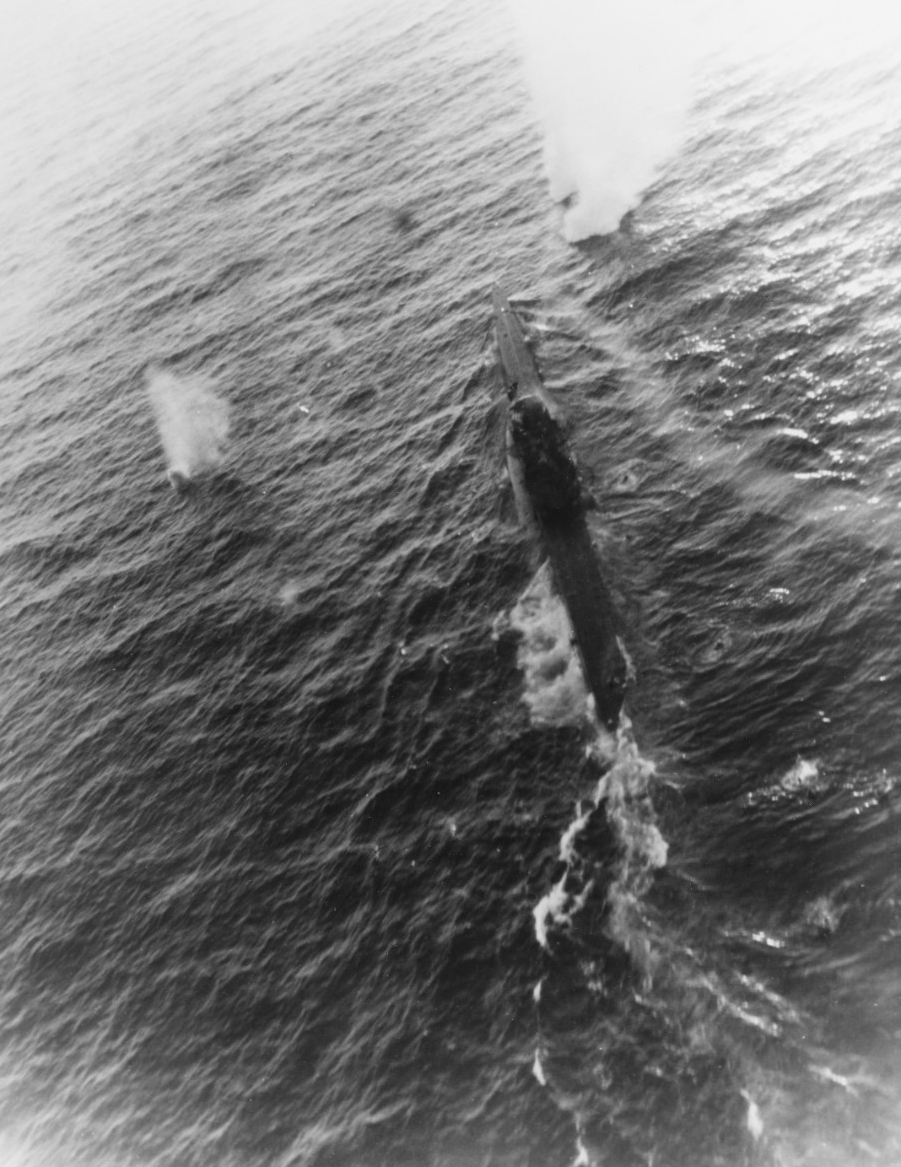 Aerial view of an attack on a submarine underway.
