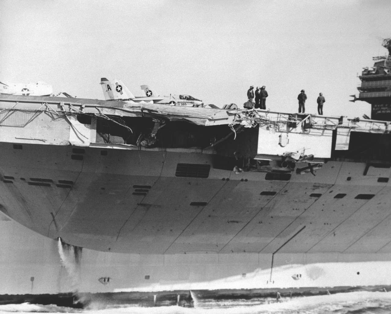 Damaged side of an aircraft carrier in dry dock.