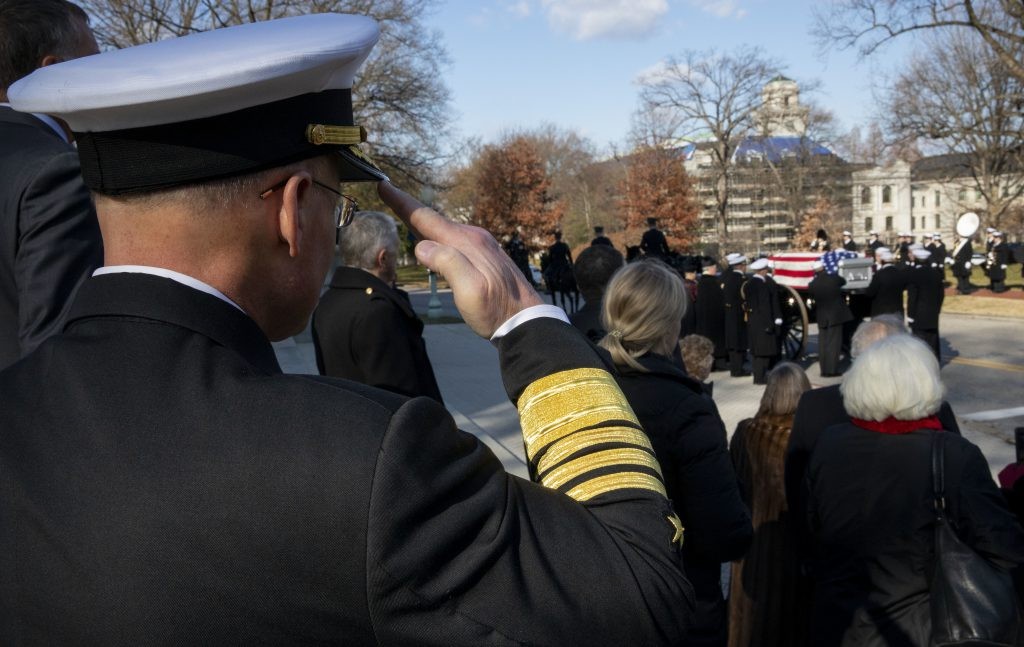 191218-N-TR763-0138 ANNAPOLIS, Md. (Dec. 18, 2019) – Chief of Naval Operations (CNO) Adm. Mike Gilday salutes the funeral procession for retired Adm. James Holloway III, the 20th Chief of Naval Operations. Holloway was born Feb. 23, 1922, and ser...